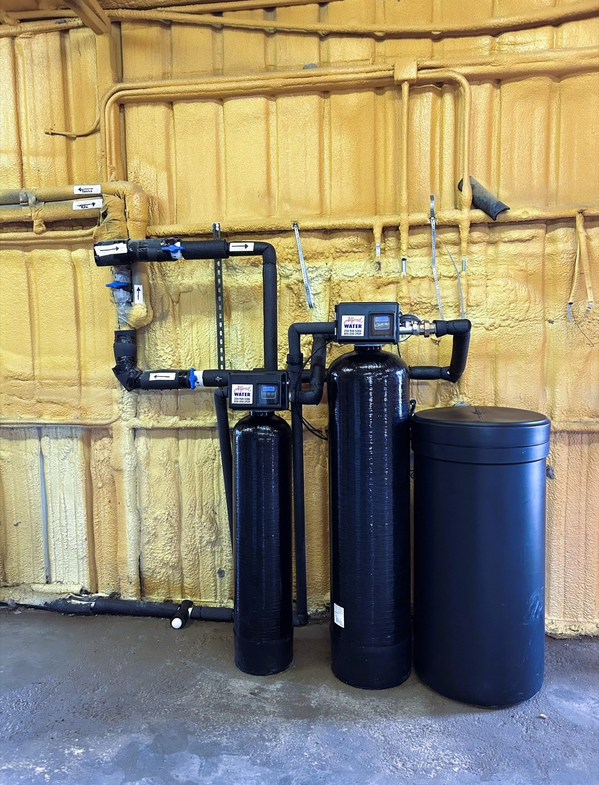 Whole-home softener and brine tank installation.